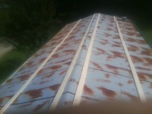 Rusted metal roof panels with new wood purlins before replacement — Storm Damage Roof Repair in Maspeth by Roofing Brothers